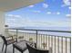 Relaxing ocean view from the balcony seating area with chairs and end table overlooking the beach at 107 S Ocean Blvd. # 602, Myrtle Beach, SC 29577