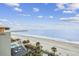 Lovely beach view from above including pool, lounge chairs, palm trees, and walking paths at 107 S Ocean Blvd. # 602, Myrtle Beach, SC 29577