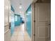 Hallway featuring blue walls and tile flooring leading to open living space at 107 S Ocean Blvd. # 602, Myrtle Beach, SC 29577