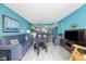 Inviting living area featuring cozy blue sofas, beach-themed art, and a seamless transition to the kitchen at 107 S Ocean Blvd. # 602, Myrtle Beach, SC 29577