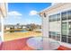 Enjoy the water view from the back patio featuring a table and sliding glass doors at 109 Deer Tree Dr., Murrells Inlet, SC 29576