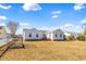 Spacious backyard featuring well-maintained lawn, a raised garden bed, and red deck, ideal for outdoor activities at 109 Deer Tree Dr., Murrells Inlet, SC 29576