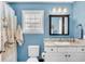 Bright bathroom features a single sink vanity, framed mirror, and decorative cat shower curtain at 109 Deer Tree Dr., Murrells Inlet, SC 29576