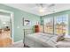 Cozy bedroom with a ceiling fan, two windows, and a brass bed frame at 109 Deer Tree Dr., Murrells Inlet, SC 29576