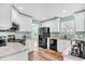 Well-equipped kitchen with granite countertops, stainless steel appliances, and white cabinetry at 109 Deer Tree Dr., Murrells Inlet, SC 29576