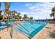 Beautiful outdoor pool surrounded by lounge chairs, palm trees, and blue umbrellas at 1105 S Ocean Blvd. # 706, Myrtle Beach, SC 29577