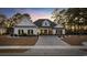 Charming single-story home featuring a manicured lawn and brick paver driveway at twilight at 1109 Wigeon Dr., Conway, SC 29526