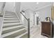 Welcoming hallway with stairs and a view into the home's modern kitchen at 1109 Wigeon Dr., Conway, SC 29526