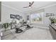 Bright living room featuring comfortable gray lounge chairs, a ceiling fan, and an abundance of natural light at 1109 Wigeon Dr., Conway, SC 29526