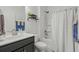 Well-lit bathroom with a shower-tub combo, dark vanity, and modern fixtures at 1118 Prescott Circle, Myrtle Beach, SC 29577