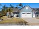 Charming single-story home with a well-manicured lawn, palm tree, and attached two-car garage at 1118 Prescott Circle, Myrtle Beach, SC 29577