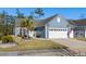 Inviting exterior of a well-maintained home showcasing blue siding, a two car garage, and lovely curb appeal with a palm tree at 1118 Prescott Circle, Myrtle Beach, SC 29577