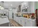 Modern kitchen featuring white cabinetry, stainless steel appliances, and a stylish backsplash at 1118 Prescott Circle, Myrtle Beach, SC 29577