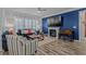 Cozy living room showcasing a fireplace, comfortable seating, and a stylish blue accent wall with wood paneling at 1118 Prescott Circle, Myrtle Beach, SC 29577