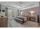 Beautiful main bedroom featuring decorative trim wall, tray ceilings, and large windows at 1118 Prescott Circle, Myrtle Beach, SC 29577