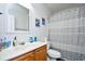 Bright bathroom featuring tile floors, a wood cabinet vanity, and a shower/tub combo with shower curtain at 1144 Harvest Circle # 1144, Myrtle Beach, SC 29579