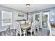 Dining room with gray walls, modern wood-look floors, and a sliding glass door to the backyard at 1144 Harvest Circle # 1144, Myrtle Beach, SC 29579