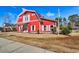 Charming red barn-style building with white trim, offering a unique and inviting exterior at 1144 Harvest Circle # 1144, Myrtle Beach, SC 29579