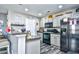 Well-lit kitchen with stainless steel appliances, gray cabinets, granite countertops, and modern flooring at 1144 Harvest Circle # 1144, Myrtle Beach, SC 29579