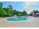 Large community pool with fountains, surrounded by palm trees and plenty of lounge chairs at 1144 Harvest Circle # 1144, Myrtle Beach, SC 29579