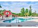 Beautiful community pool with a red barn building backdrop, complete with lounge chairs and a playground at 1144 Harvest Circle # 1144, Myrtle Beach, SC 29579