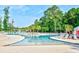 Expansive community pool area with ample seating, surrounded by lush landscaping and palm trees at 1144 Harvest Circle # 1144, Myrtle Beach, SC 29579