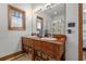 Bathroom with a wood framed window, double vanity, large mirror and glass door shower at 136 Da Gullah Way # B, Pawleys Island, SC 29585