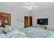 Bedroom with a ceiling fan, tv, and white furniture with views into another bedroom at 136 Da Gullah Way # B, Pawleys Island, SC 29585