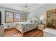 Bedroom with three windows and a white frame bed and matching end table with a lamp at 136 Da Gullah Way # B, Pawleys Island, SC 29585