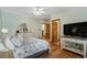 Bright bedroom with a ceiling fan, light blue walls, wood floors and a mounted television at 136 Da Gullah Way # B, Pawleys Island, SC 29585