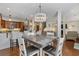 Bright dining area with a modern chandelier, open to the kitchen and living area at 136 Da Gullah Way # B, Pawleys Island, SC 29585