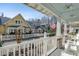 Inviting front porch view with white picket fence, rocking chairs, and patriotic American flags on a sunny day at 136 Da Gullah Way # B, Pawleys Island, SC 29585