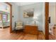 Hallway with wood flooring, a lamp on a chest, chair and views to two other bedrooms at 136 Da Gullah Way # B, Pawleys Island, SC 29585