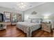 Bright main bedroom with wood floors, coastal decor, a ceiling fan, and large windows for natural light at 136 Da Gullah Way # B, Pawleys Island, SC 29585