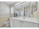 Bright bathroom with a large mirror, decorative wallpaper, and a white vanity at 1450 Portrait Circle # 1450, Myrtle Beach, SC 29577