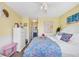 Inviting bedroom with a floral comforter, white dresser, and bright yellow walls at 1450 Portrait Circle # 1450, Myrtle Beach, SC 29577