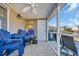 Relaxing screened porch with blue chairs, ceiling fan, and view of the community at 1450 Portrait Circle # 1450, Myrtle Beach, SC 29577