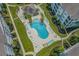 Aerial view of resort-style pool with lounge area, lush landscaping, and condominium buildings at 149 Ella Kinley Circle # 405, Myrtle Beach, SC 29588