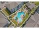 Aerial view of resort-style pool, lounge area, and lush landscaping in condominium community at 149 Ella Kinley Circle # 405, Myrtle Beach, SC 29588