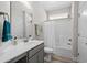 Bright bathroom featuring a gray vanity, white countertop, and shower with white tile at 149 Ella Kinley Circle # 405, Myrtle Beach, SC 29588