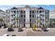 Spacious condo building with well-kept landscaping, ample parking, and easy access to all amenities at 149 Ella Kinley Circle # 405, Myrtle Beach, SC 29588