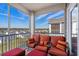 Inviting screened porch with outdoor seating and peaceful neighborhood view at 149 Ella Kinley Circle # 405, Myrtle Beach, SC 29588