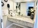 Modern bathroom with granite countertop, white towels, and a view into the kitchen at 1501 S Ocean Blvd. # 841, Myrtle Beach, SC 29577