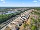 An aerial view of the homes, lake, and community streets at 156 Legends Village Loop, Myrtle Beach, SC 29579