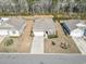 Aerial view of the property with a long driveway, manicured lawn, and surrounding houses at 156 Legends Village Loop, Myrtle Beach, SC 29579
