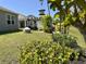 Lush backyard featuring a pergola with seating, a fire pit, and manicured landscaping at 156 Legends Village Loop, Myrtle Beach, SC 29579