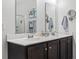 Bathroom featuring a white countertop, double sinks, a mirror and dark brown cabinetry at 156 Legends Village Loop, Myrtle Beach, SC 29579