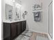 Modern bathroom featuring a double vanity, framed mirrors, and stylish wood look flooring at 156 Legends Village Loop, Myrtle Beach, SC 29579