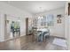 Sunlit dining area with a rustic dining set, a large mirror, and stylish decor creating a cozy atmosphere at 156 Legends Village Loop, Myrtle Beach, SC 29579