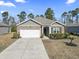 Beautiful single-Gathering home showcasing a spacious driveway and a well-maintained lawn and manicured landscaping at 156 Legends Village Loop, Myrtle Beach, SC 29579